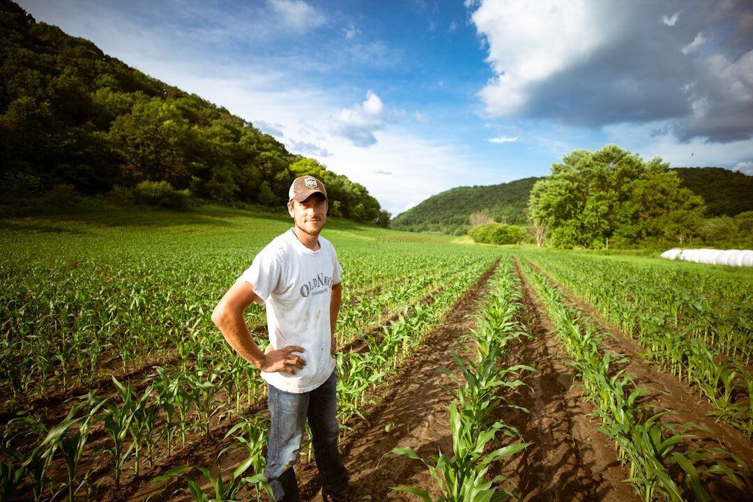 Portrait of a young Danish farmer standing in a field