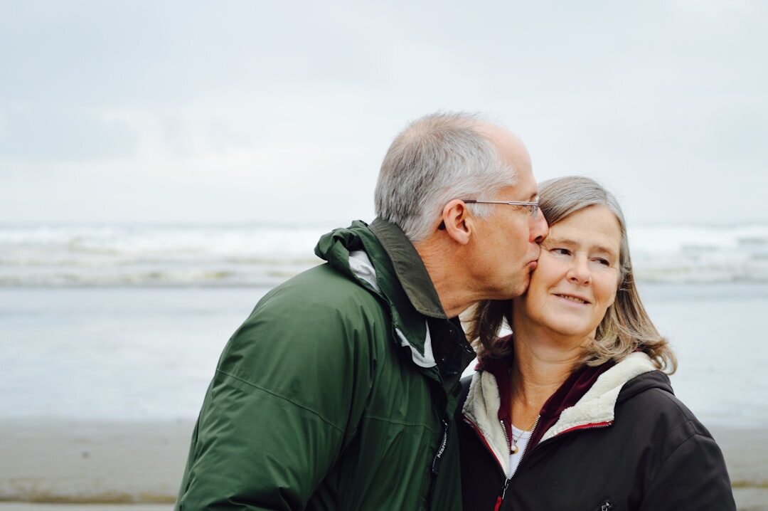 Portrait of an elderly Danish couple sitting outside their home